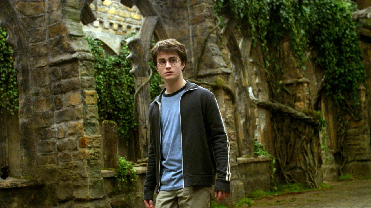 Man in Black Jacket and Gray Pants Standing Near Brown Concrete Wall During Daytime. Wallpaper in 1280x720 Resolution