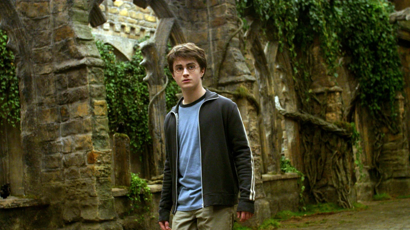 Man in Black Jacket and Gray Pants Standing Near Brown Concrete Wall During Daytime. Wallpaper in 1366x768 Resolution