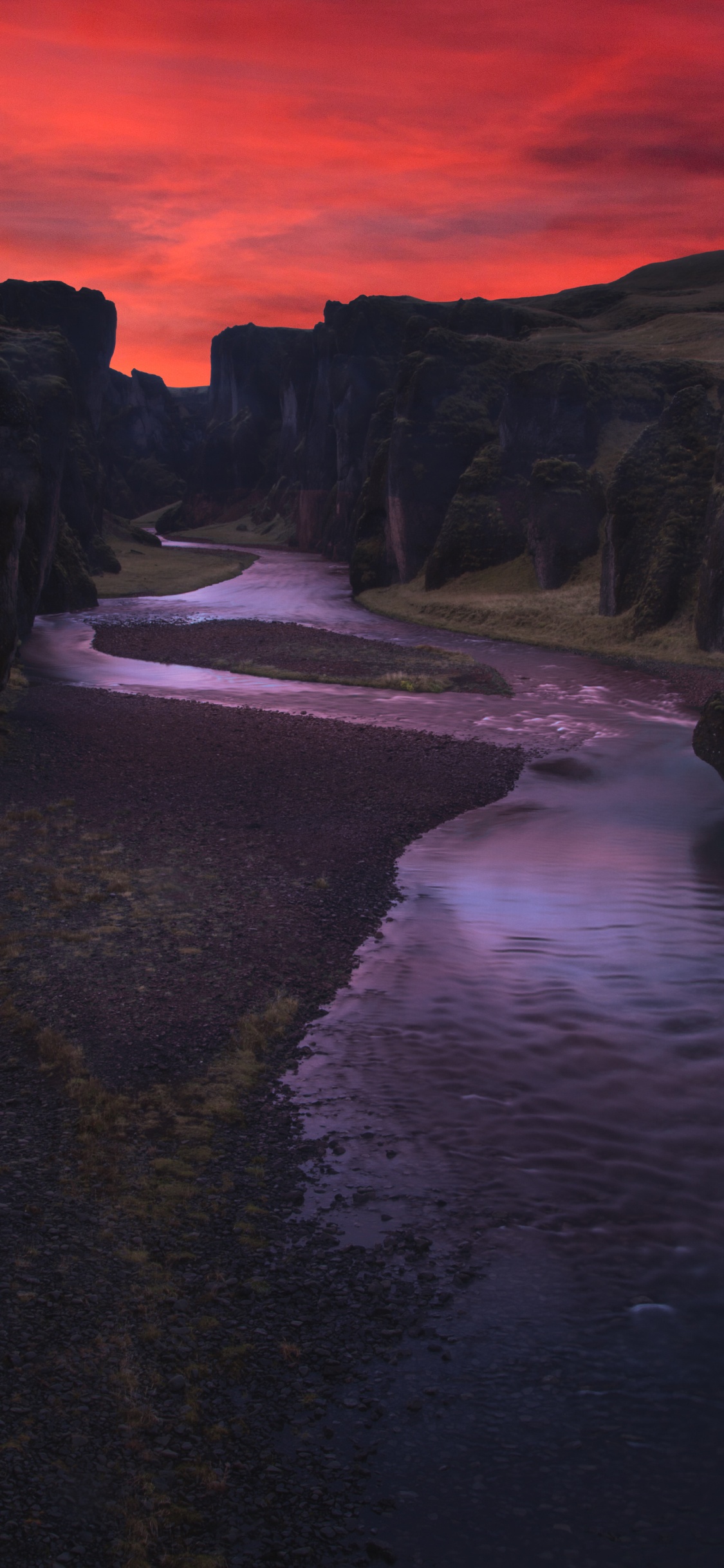 Body of Water Between Mountain During Sunset. Wallpaper in 1125x2436 Resolution