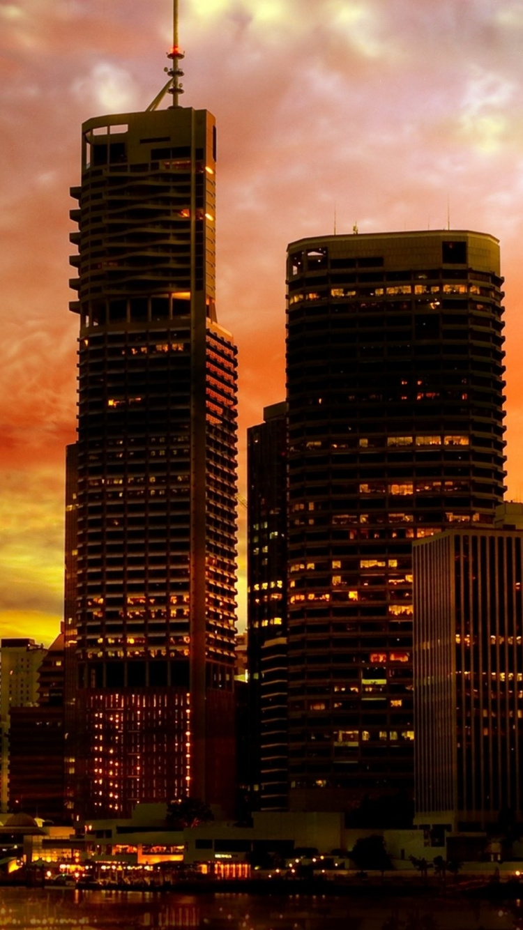 City Skyline Under Cloudy Sky During Night Time. Wallpaper in 750x1334 Resolution