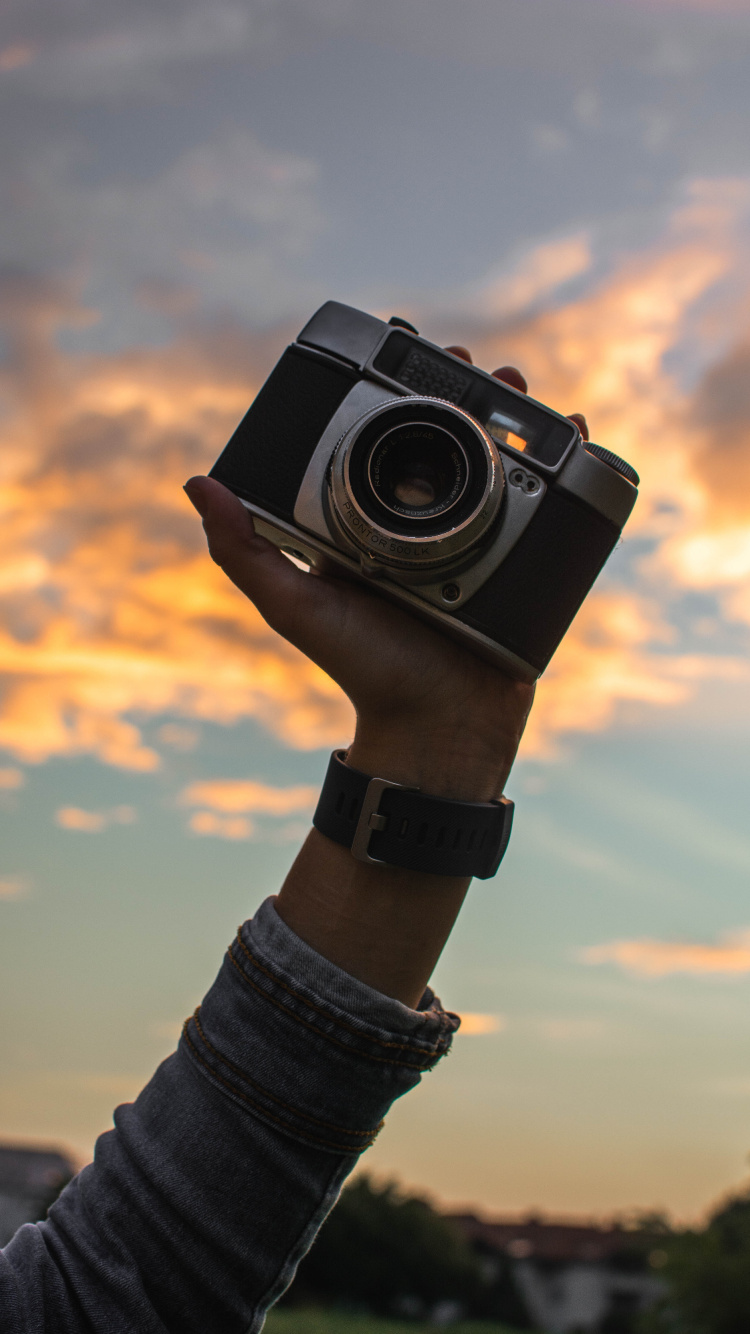 Person Holding Black and Silver Camera. Wallpaper in 750x1334 Resolution