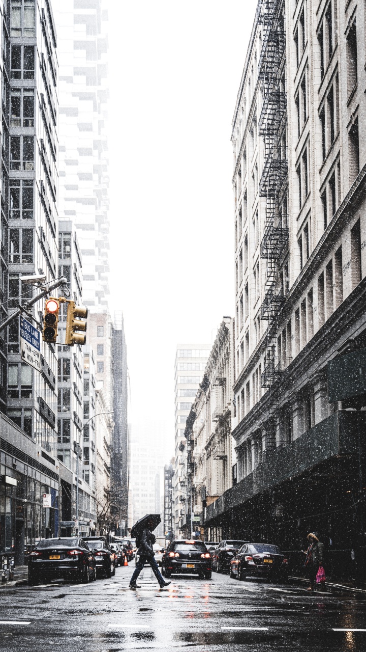 People Walking on Street Between High Rise Buildings During Daytime. Wallpaper in 720x1280 Resolution