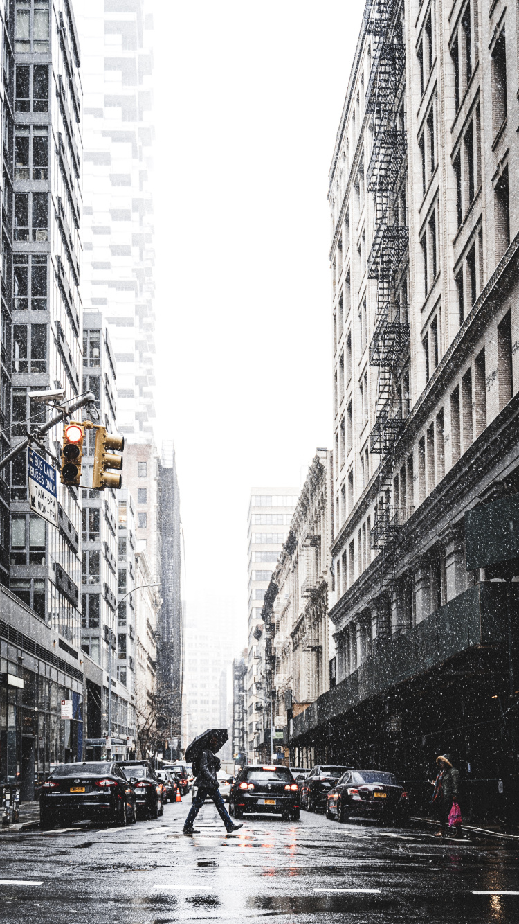 People Walking on Street Between High Rise Buildings During Daytime. Wallpaper in 750x1334 Resolution