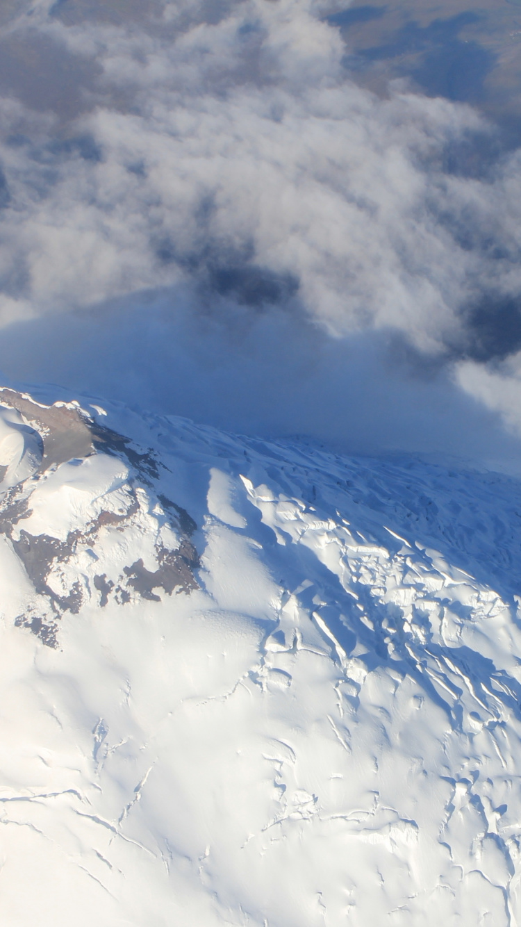 White Clouds Over Snow Covered Mountain. Wallpaper in 750x1334 Resolution