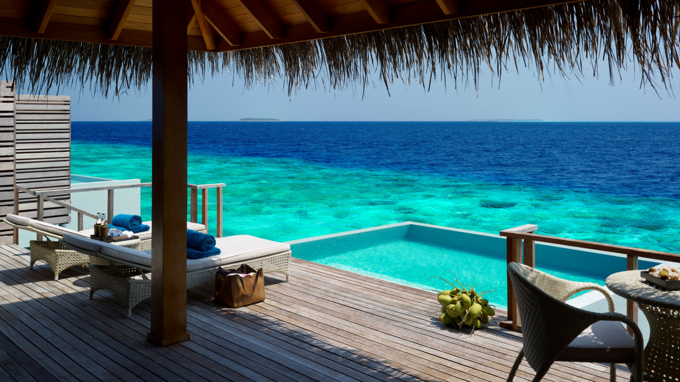 Brown Wooden Table and Chairs on Brown Wooden Deck Near Blue Sea During Daytime. Wallpaper in 1366x768 Resolution