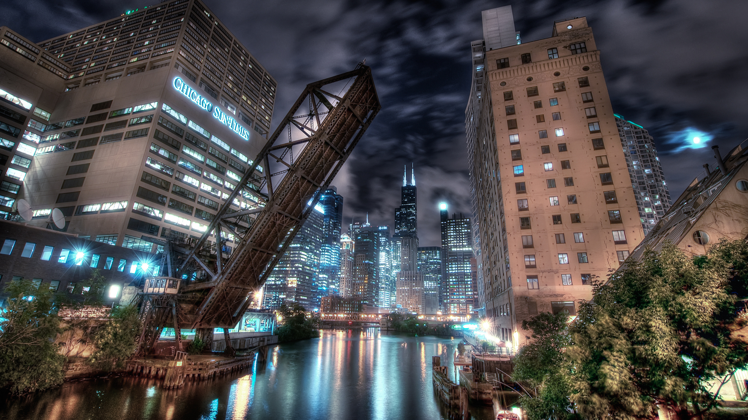 City Buildings Near Body of Water During Night Time. Wallpaper in 2560x1440 Resolution