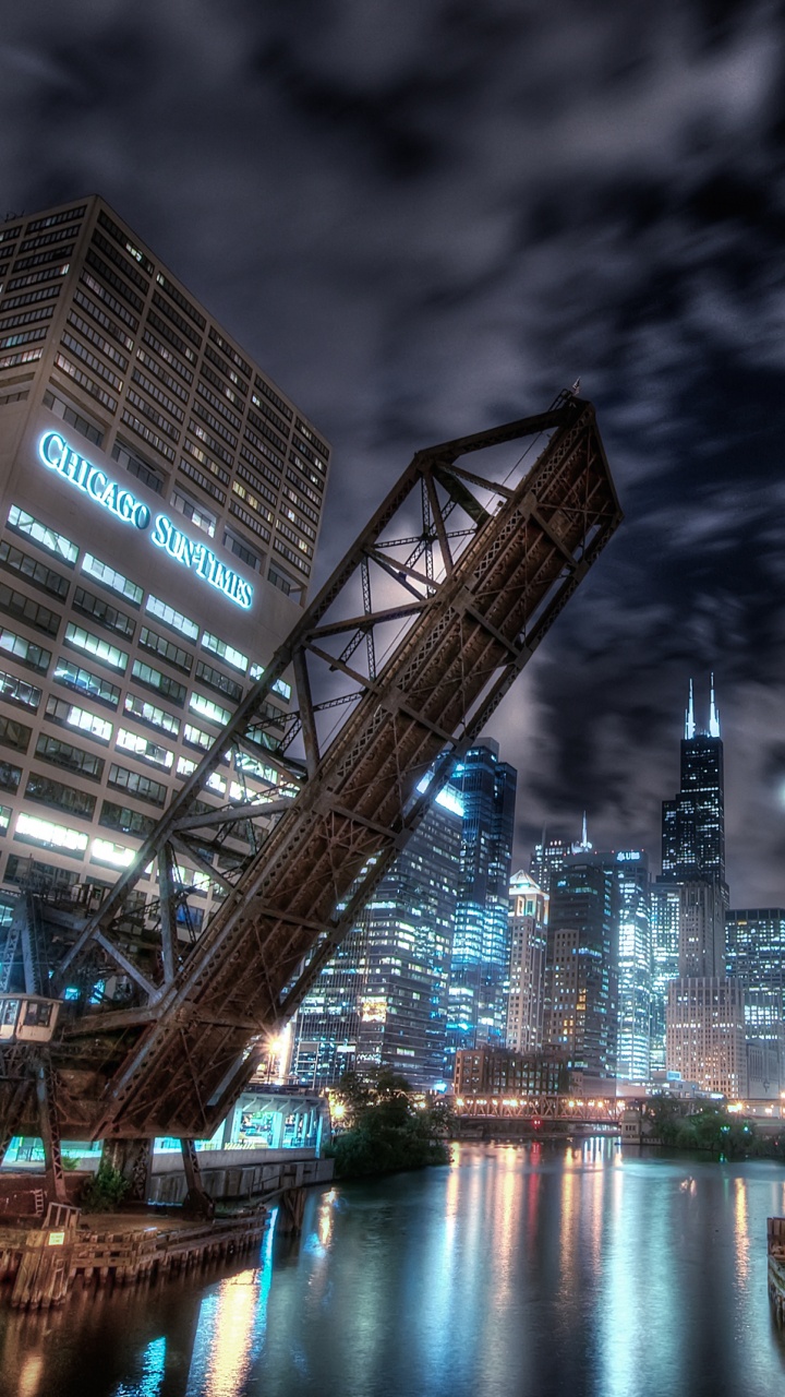 City Buildings Near Body of Water During Night Time. Wallpaper in 720x1280 Resolution