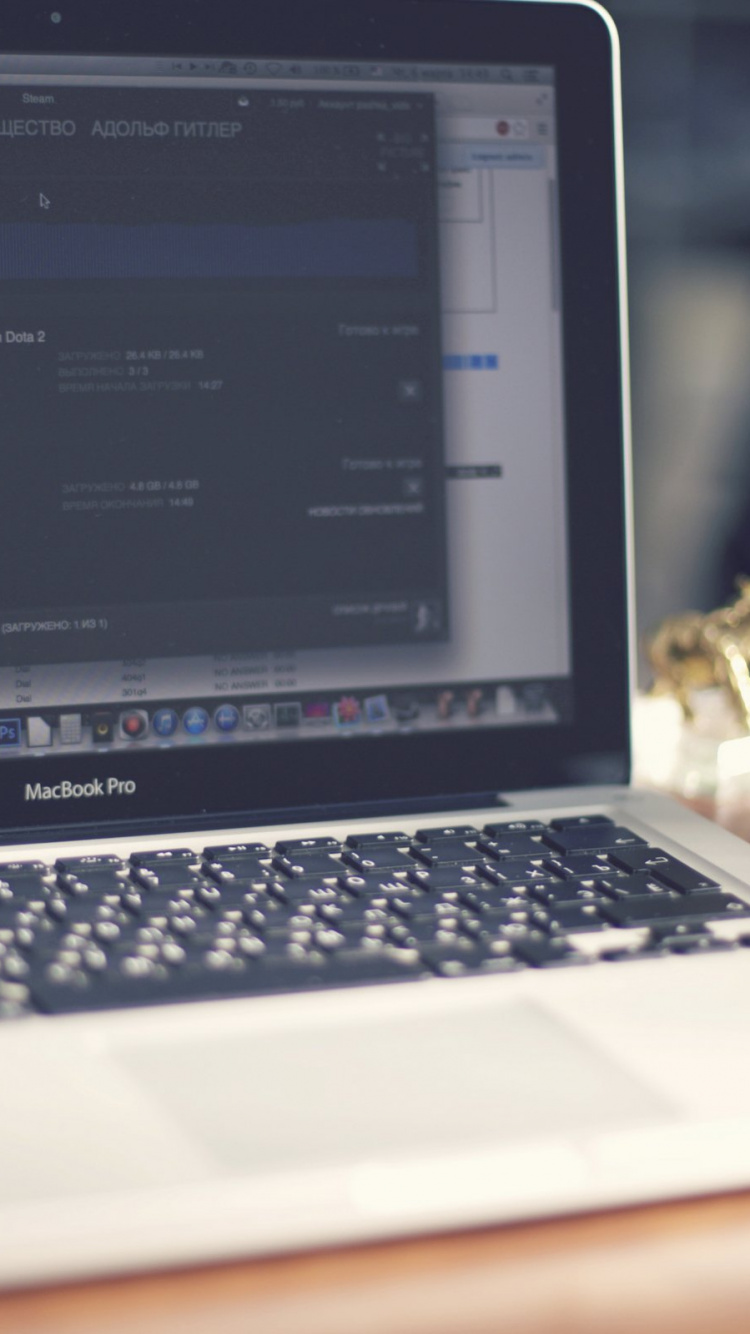 Macbook Pro on Brown Wooden Table. Wallpaper in 750x1334 Resolution