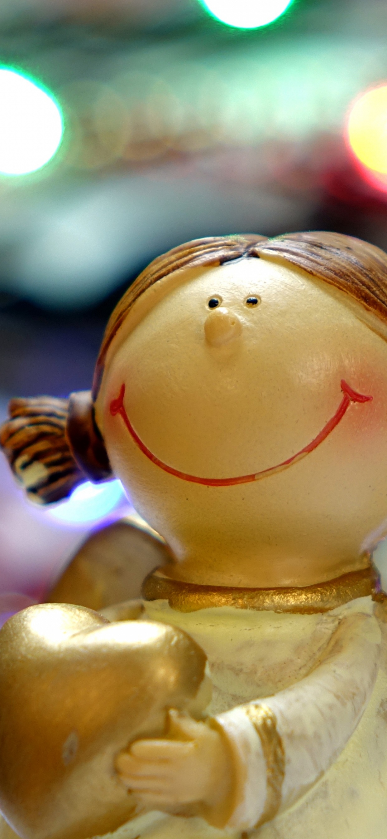 White Angel Ceramic Figurine in Bokeh Photography. Wallpaper in 1242x2688 Resolution