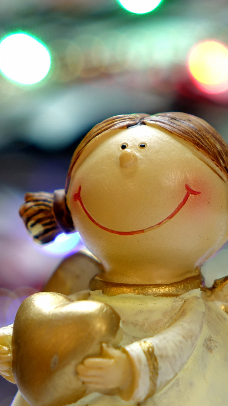 White Angel Ceramic Figurine in Bokeh Photography. Wallpaper in 750x1334 Resolution