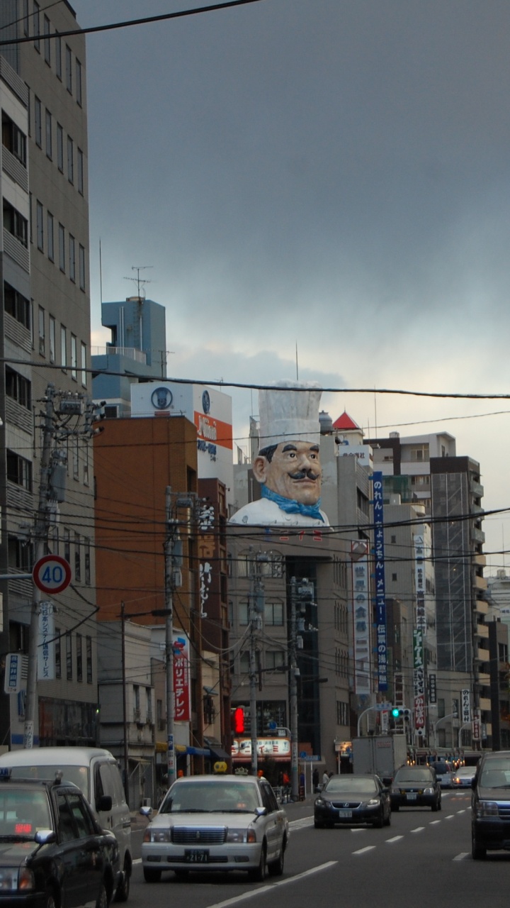 Cars on Road Between High Rise Buildings During Daytime. Wallpaper in 720x1280 Resolution