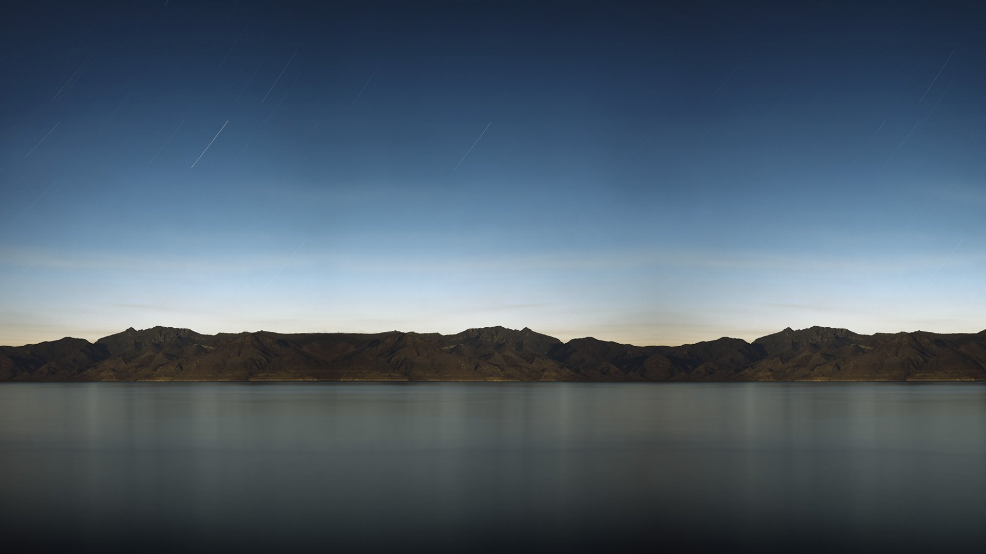 Brown Mountain Beside Body of Water During Daytime. Wallpaper in 1920x1080 Resolution