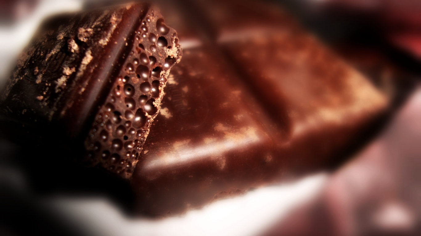 Brown Chocolate Bar on White Textile. Wallpaper in 1366x768 Resolution