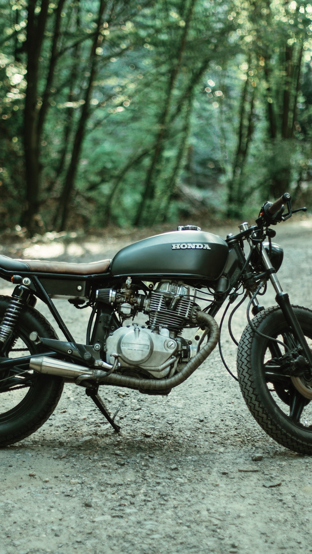 Black Motorcycle Parked on Gray Dirt Road During Daytime. Wallpaper in 1080x1920 Resolution