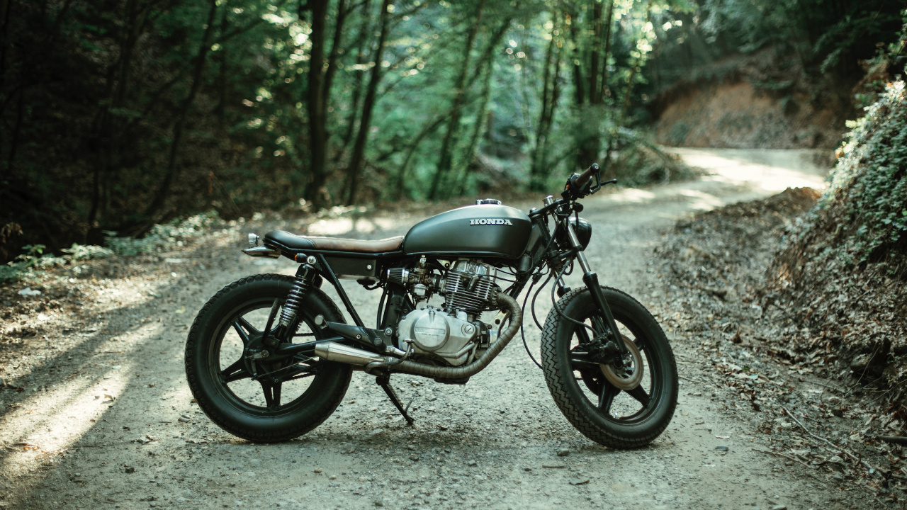 Black Motorcycle Parked on Gray Dirt Road During Daytime. Wallpaper in 1280x720 Resolution