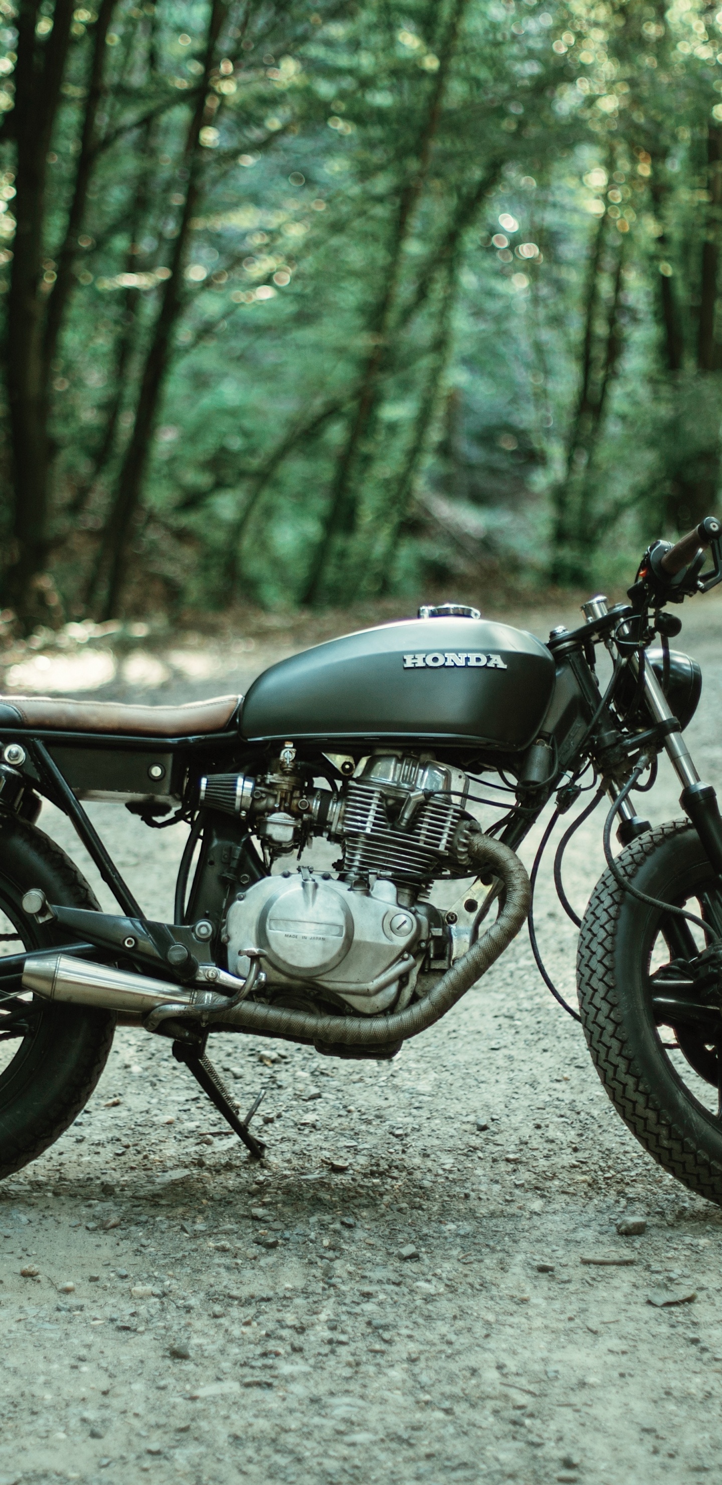 Black Motorcycle Parked on Gray Dirt Road During Daytime. Wallpaper in 1440x2960 Resolution
