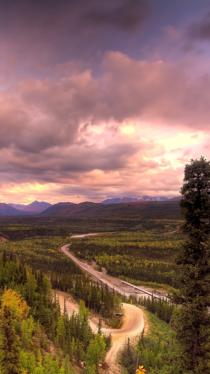 Green Trees and Mountains Under Gray Clouds. Wallpaper in 720x1280 Resolution