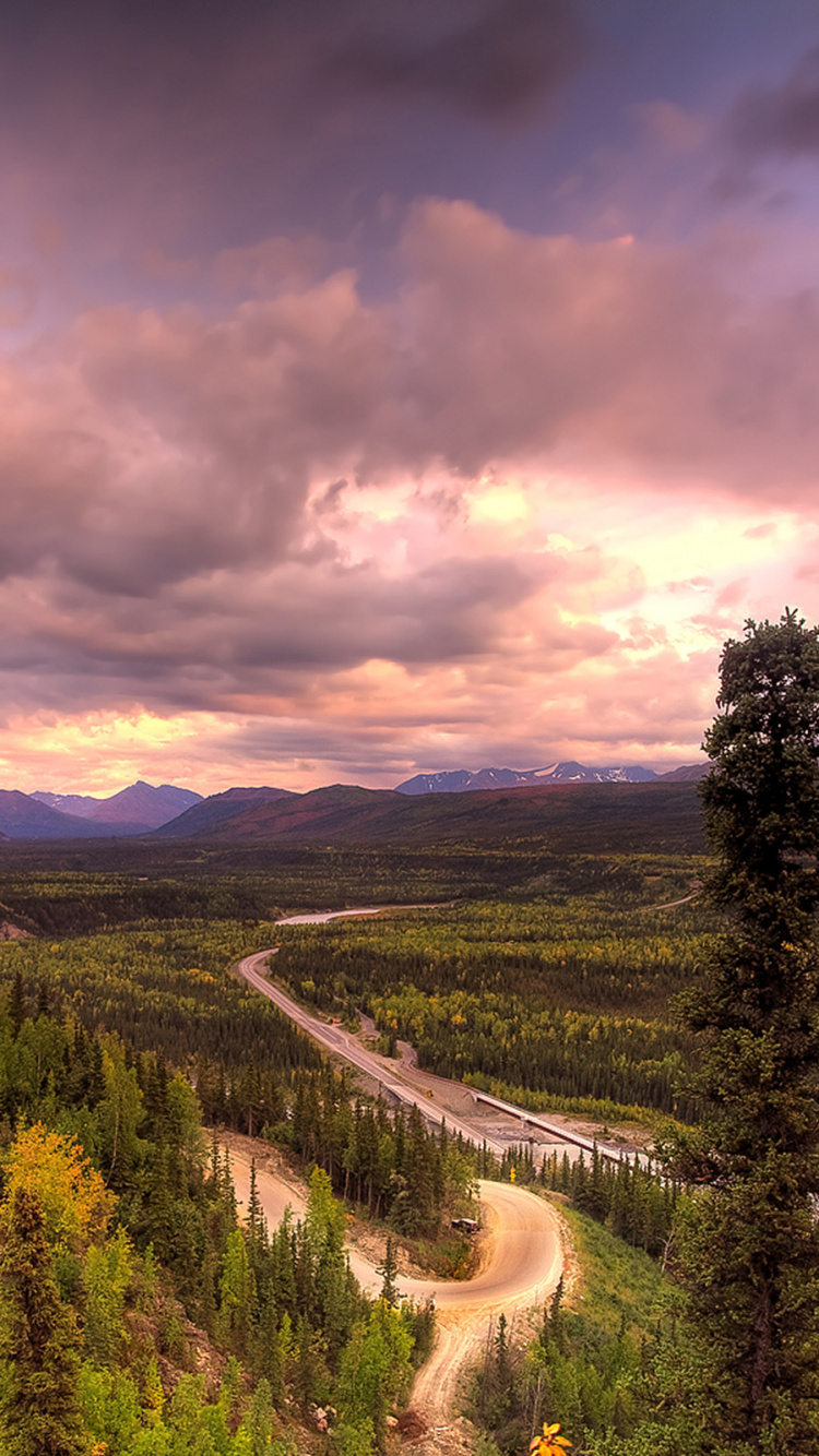 Green Trees and Mountains Under Gray Clouds. Wallpaper in 750x1334 Resolution