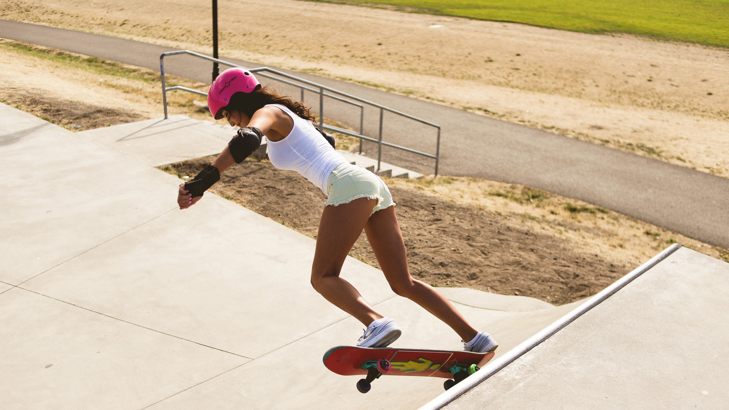 Woman in White Tank Top and White Shorts Riding on Skateboard During Daytime. Wallpaper in 2560x1440 Resolution
