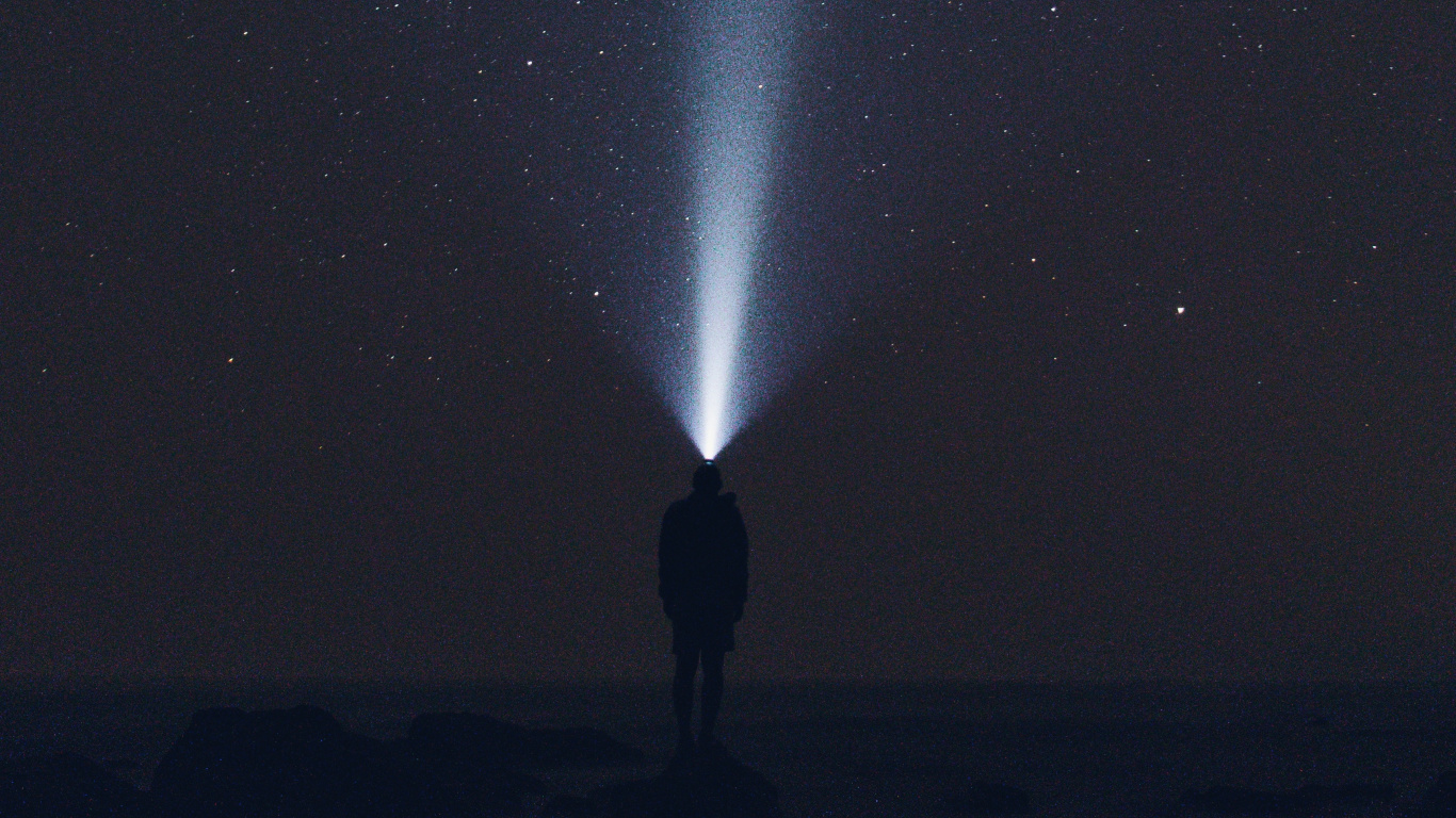 Man in Black Jacket Standing Under Starry Night. Wallpaper in 1366x768 Resolution