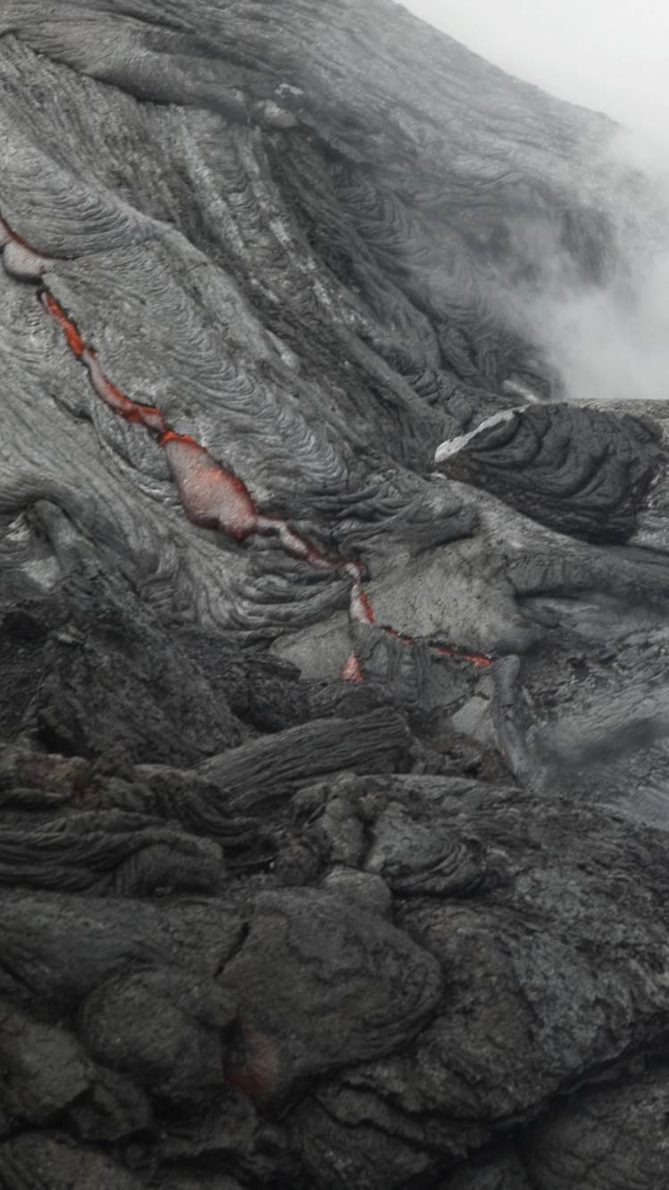 Black and Orange Smoke on Black Rock. Wallpaper in 750x1334 Resolution
