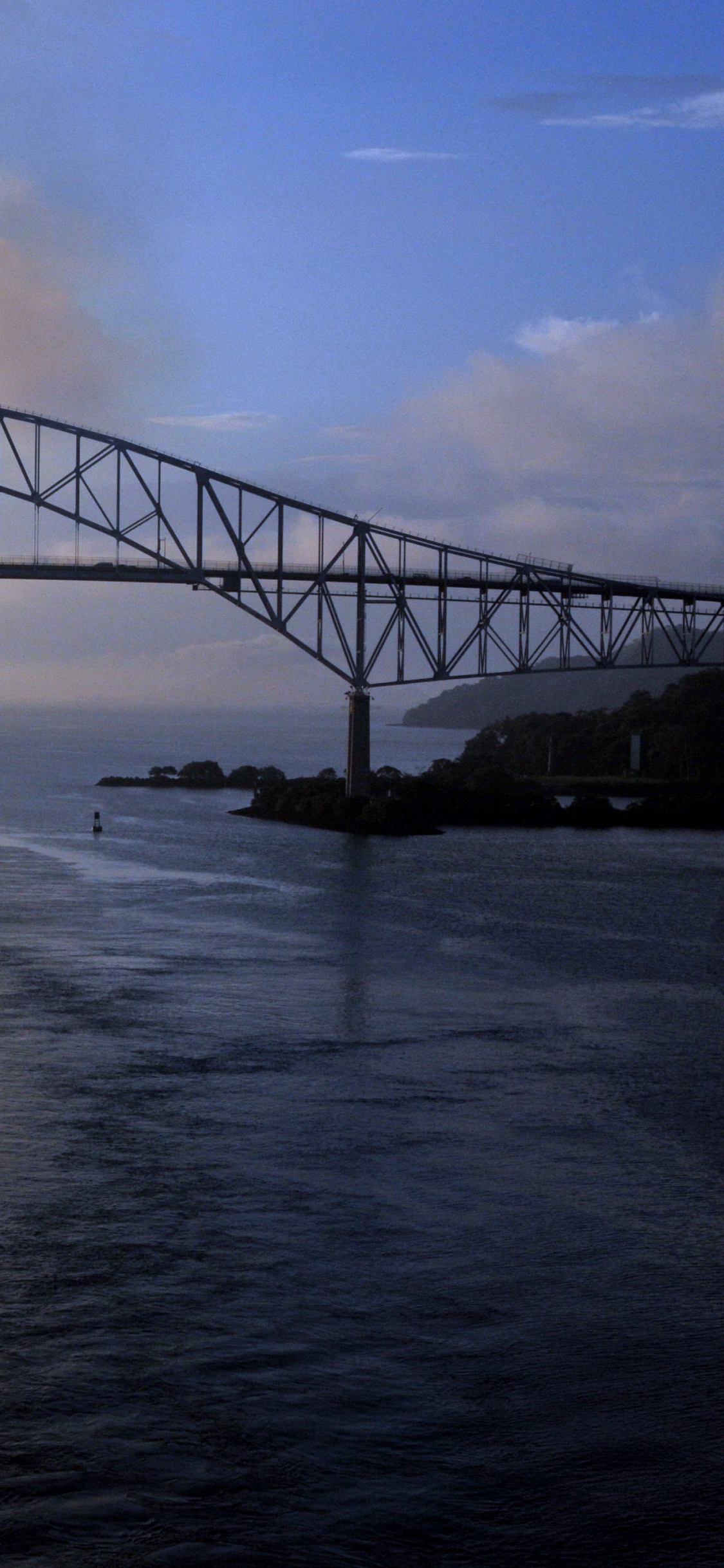 Gray Metal Bridge Over Body of Water During Daytime. Wallpaper in 1125x2436 Resolution
