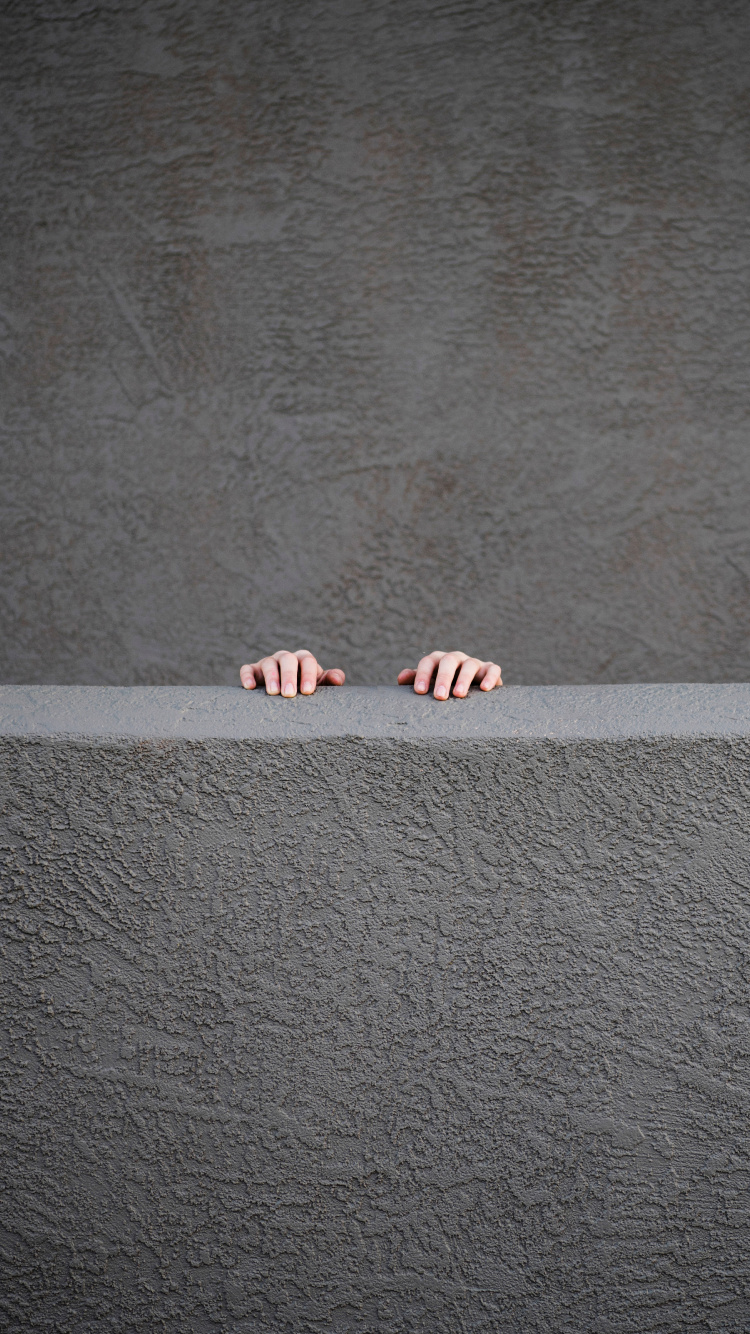 Person Standing on Gray Concrete Floor. Wallpaper in 750x1334 Resolution