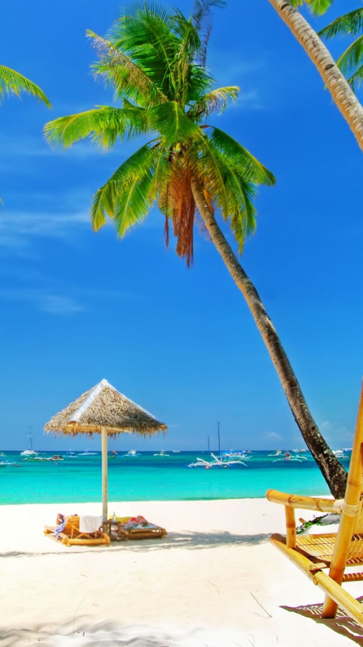 Brown Wooden Beach Lounge Chairs on Beach During Daytime. Wallpaper in 720x1280 Resolution