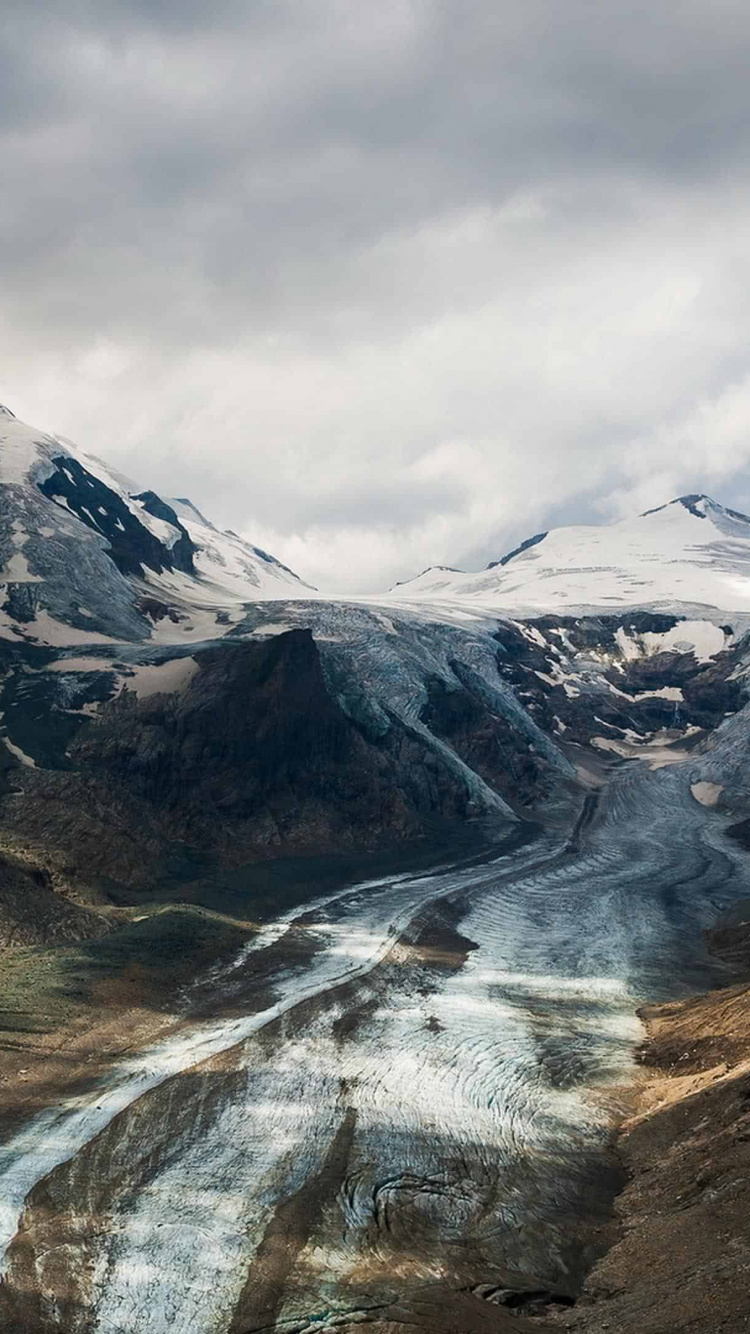 Snow Covered Mountains Under Cloudy Sky During Daytime. Wallpaper in 750x1334 Resolution