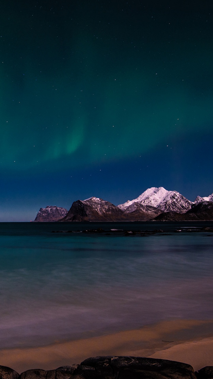Blue and Green Sky Over Rocky Shore. Wallpaper in 720x1280 Resolution