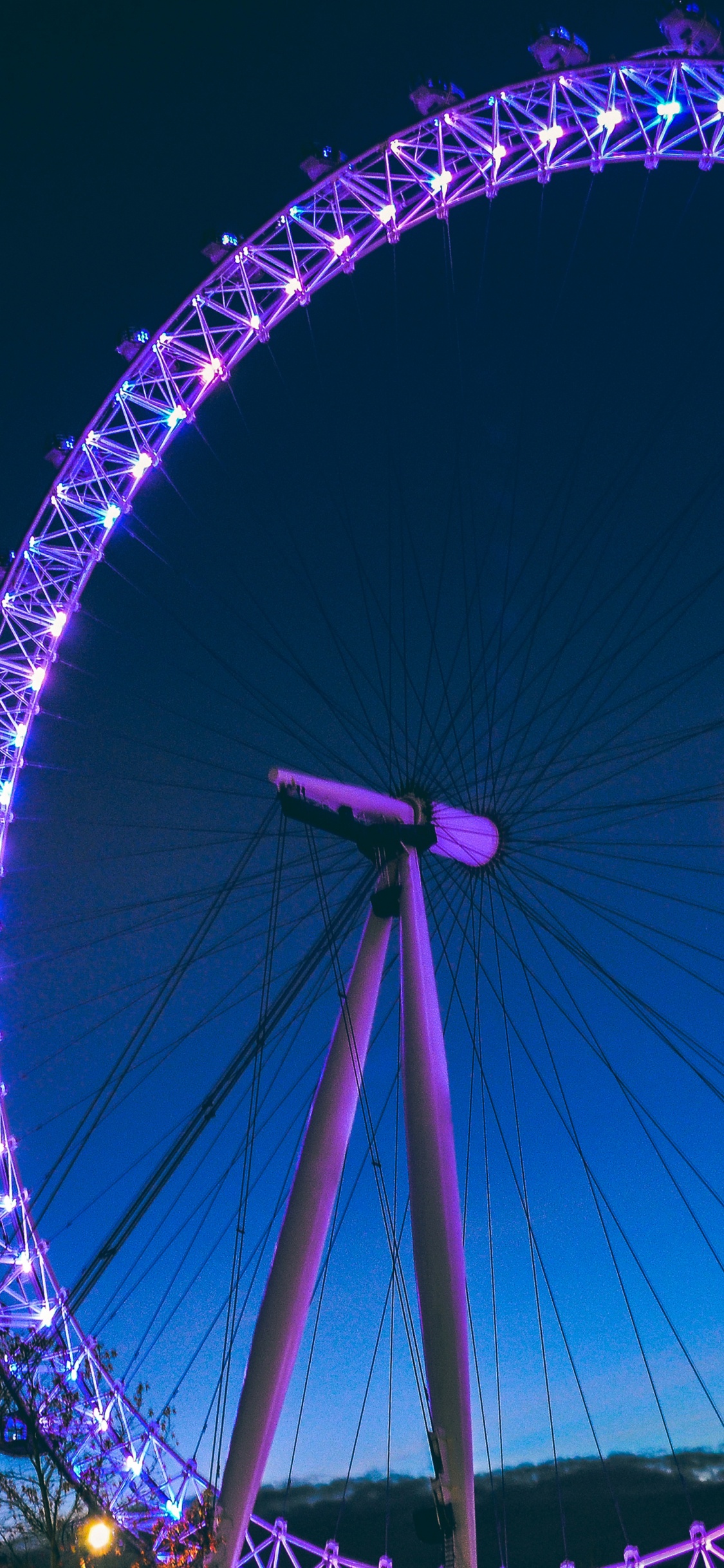Ferris Wheel With Lights Turned on During Night Time. Wallpaper in 1125x2436 Resolution