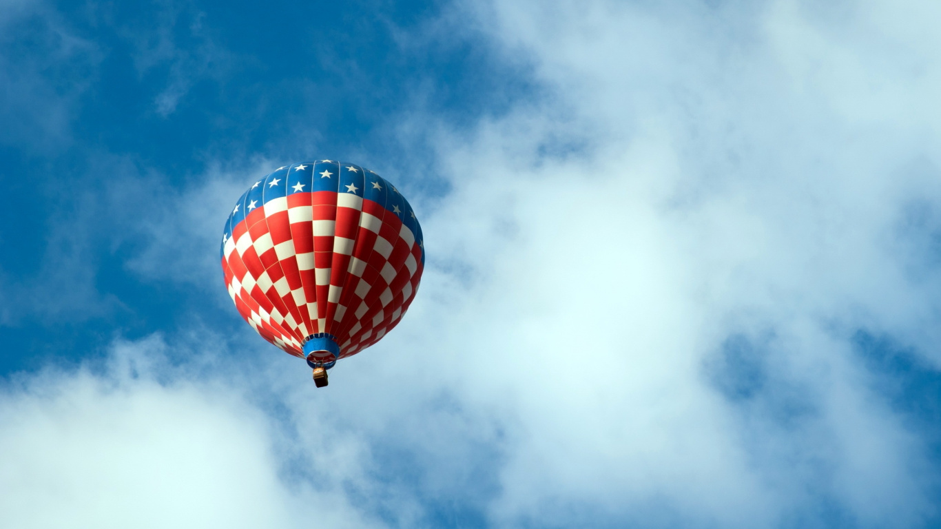 Red Blue and Yellow Hot Air Balloon in Mid Air Under White Clouds and Blue Sky. Wallpaper in 1366x768 Resolution