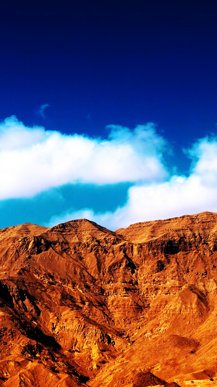 Brown Rocky Mountain Under Blue Sky During Daytime. Wallpaper in 750x1334 Resolution