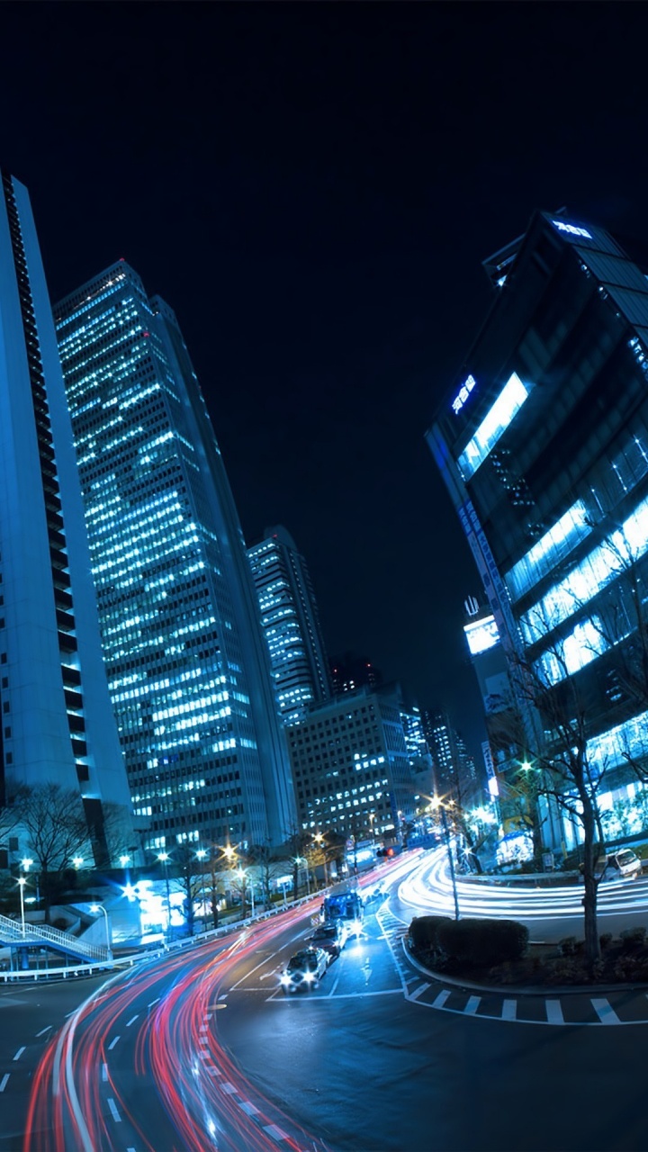 Cars on Road Near High Rise Buildings During Night Time. Wallpaper in 720x1280 Resolution