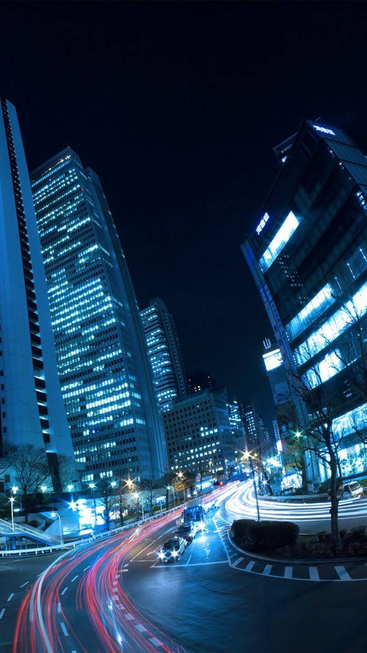 Cars on Road Near High Rise Buildings During Night Time. Wallpaper in 750x1334 Resolution