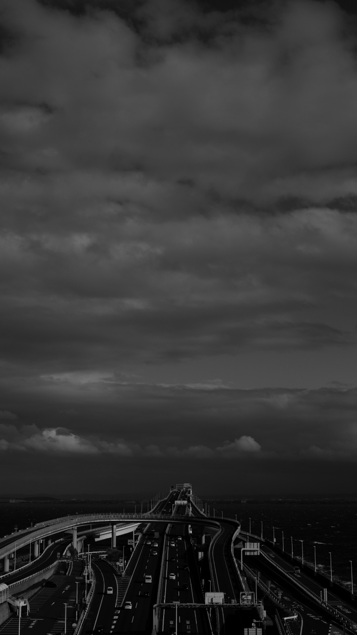 Grayscale Photo of Bridge Under Cloudy Sky. Wallpaper in 720x1280 Resolution