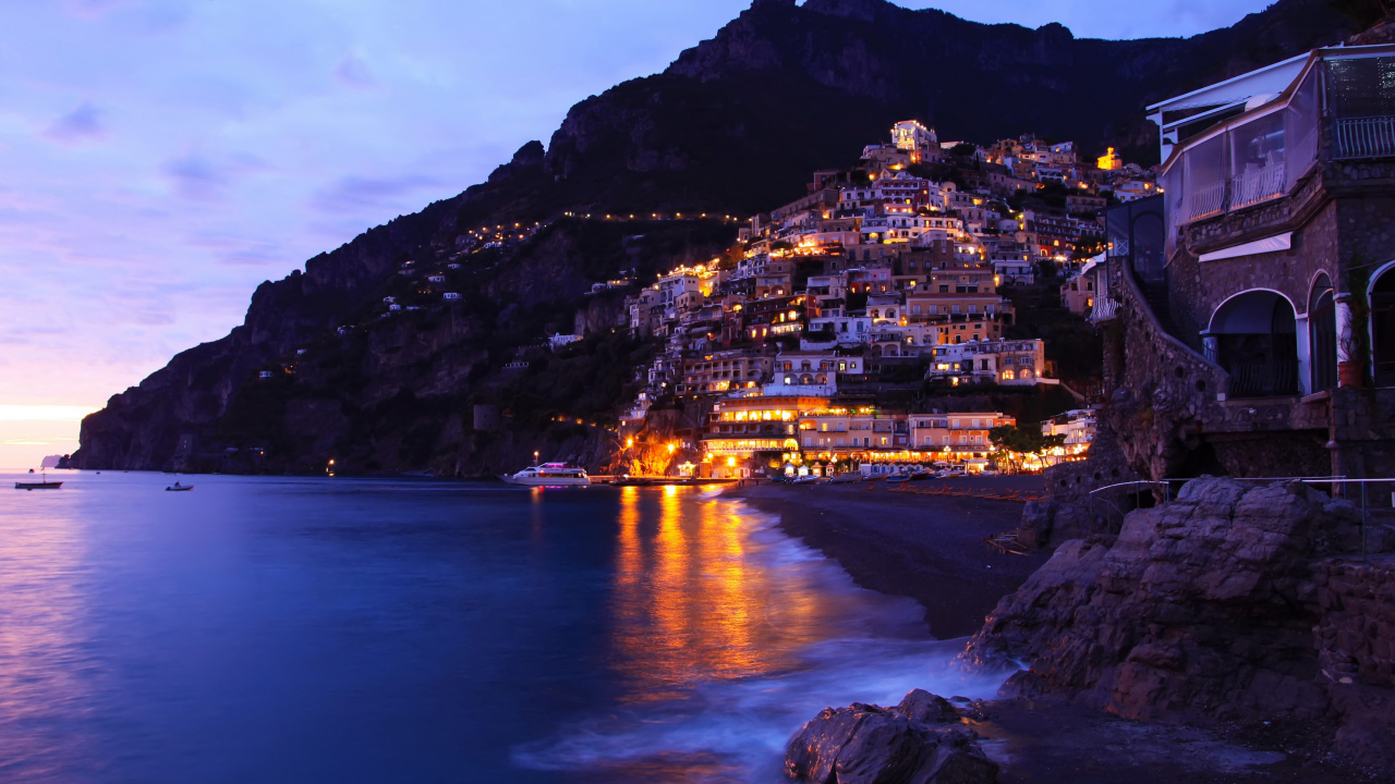 Luces de la Ciudad en la Montaña Cerca Del Cuerpo de Agua Durante la Noche. Wallpaper in 1280x720 Resolution