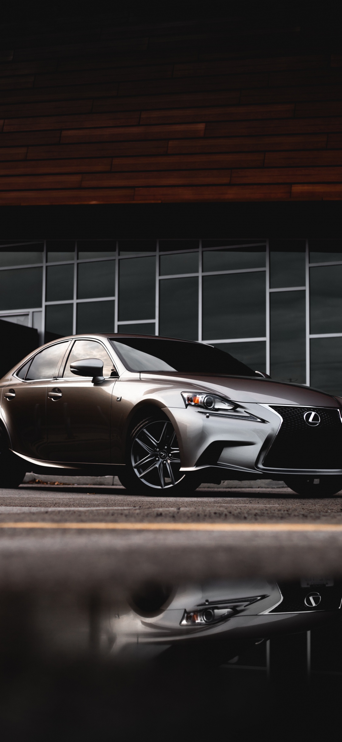 Black Porsche 911 Parked on Parking Lot. Wallpaper in 1125x2436 Resolution