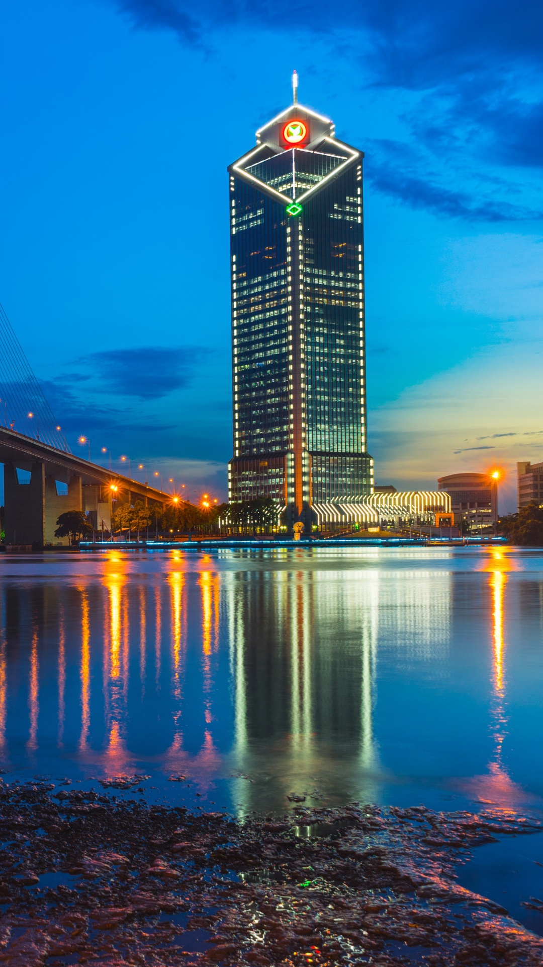 Lighted Bridge Over Water During Night Time. Wallpaper in 1080x1920 Resolution