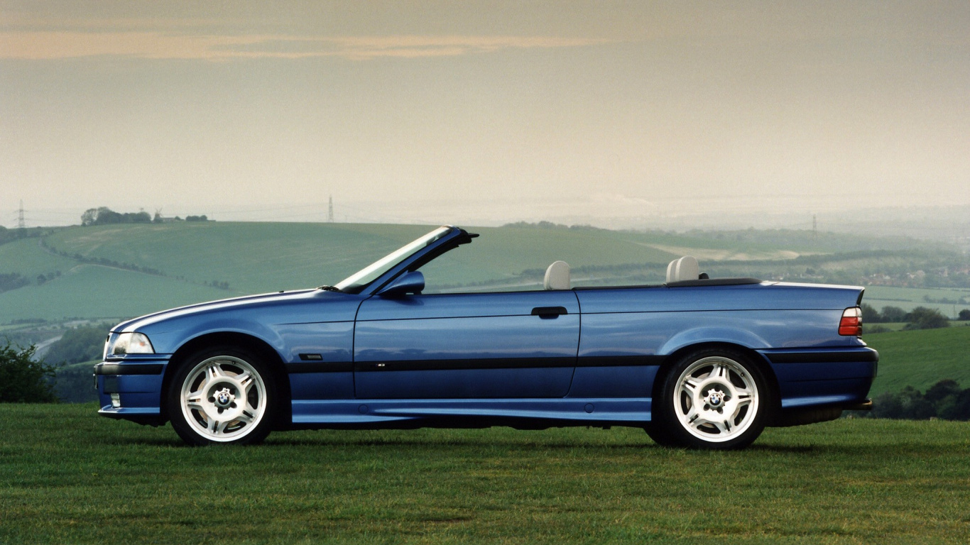 Blue Coupe on Green Grass Field During Daytime. Wallpaper in 1366x768 Resolution