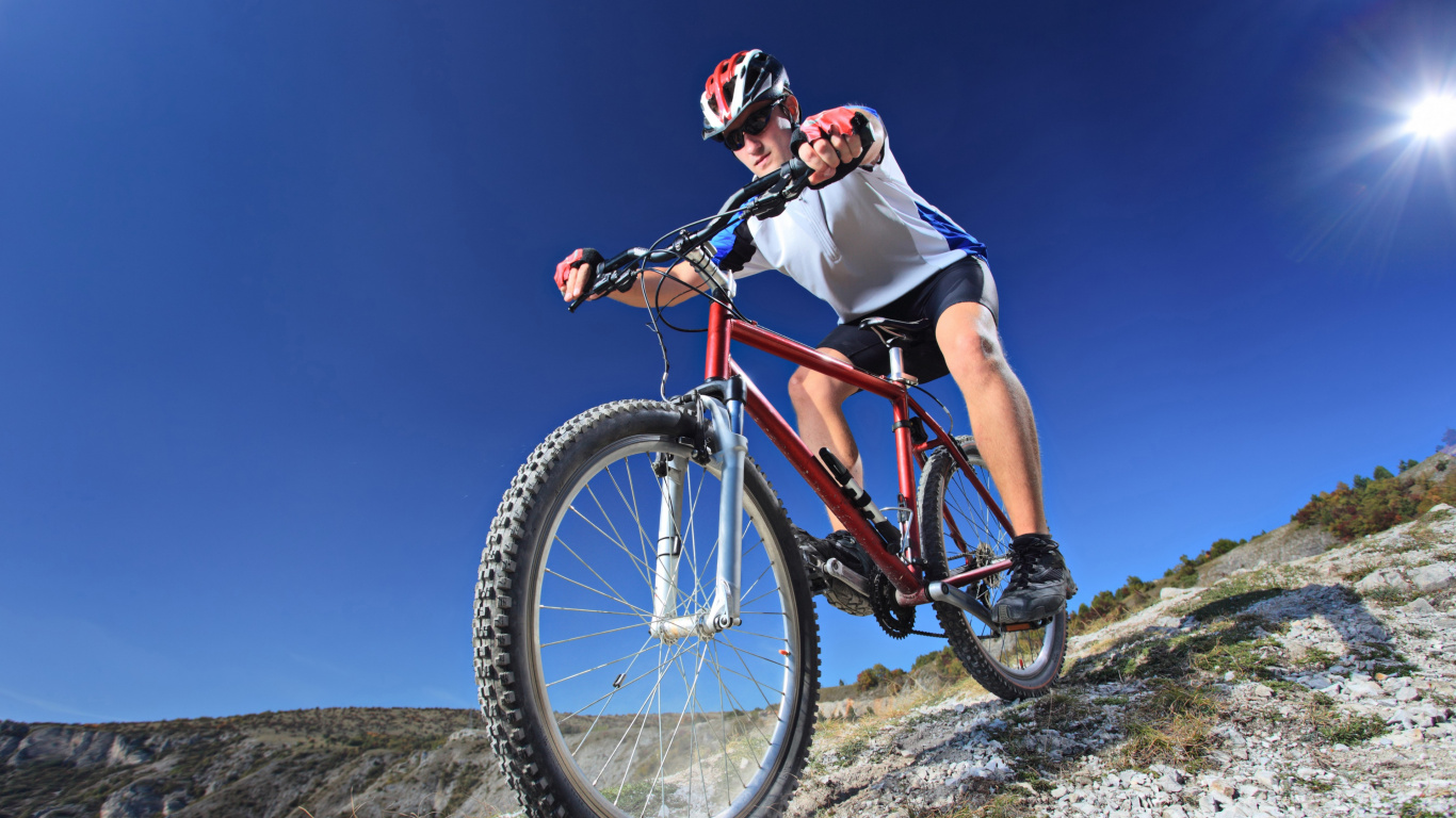 Man in White Shirt Riding on Red Mountain Bike During Daytime. Wallpaper in 1366x768 Resolution