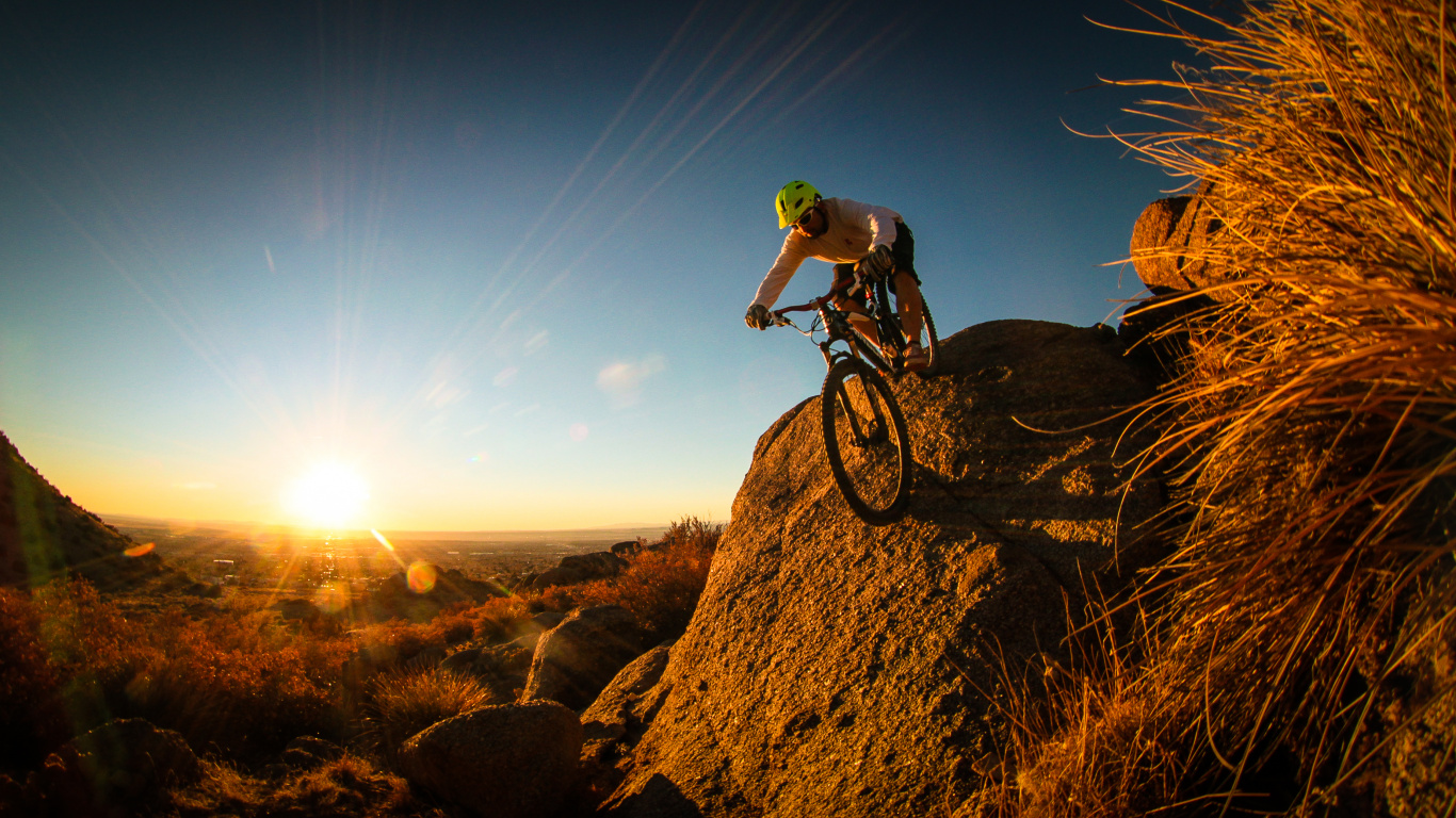 Man in Green Shirt Riding Mountain Bike on Brown Rock Mountain During Daytime. Wallpaper in 1366x768 Resolution