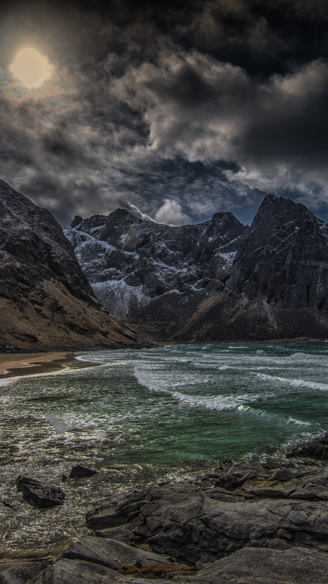 Brown Rocky Mountain Beside Body of Water Under Cloudy Sky During Daytime. Wallpaper in 1080x1920 Resolution