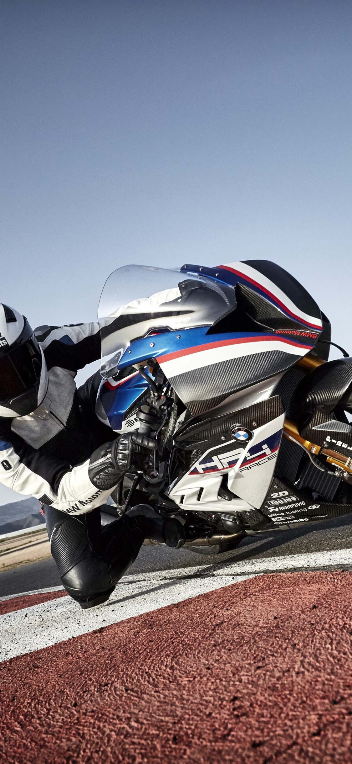 Man in Black and White Motorcycle Helmet Riding Black Sports Bike on Road During Daytime. Wallpaper in 1125x2436 Resolution