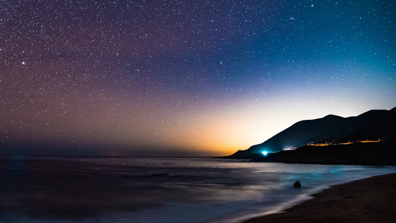 Silhouette of Mountain Near Body of Water During Night Time. Wallpaper in 1280x720 Resolution