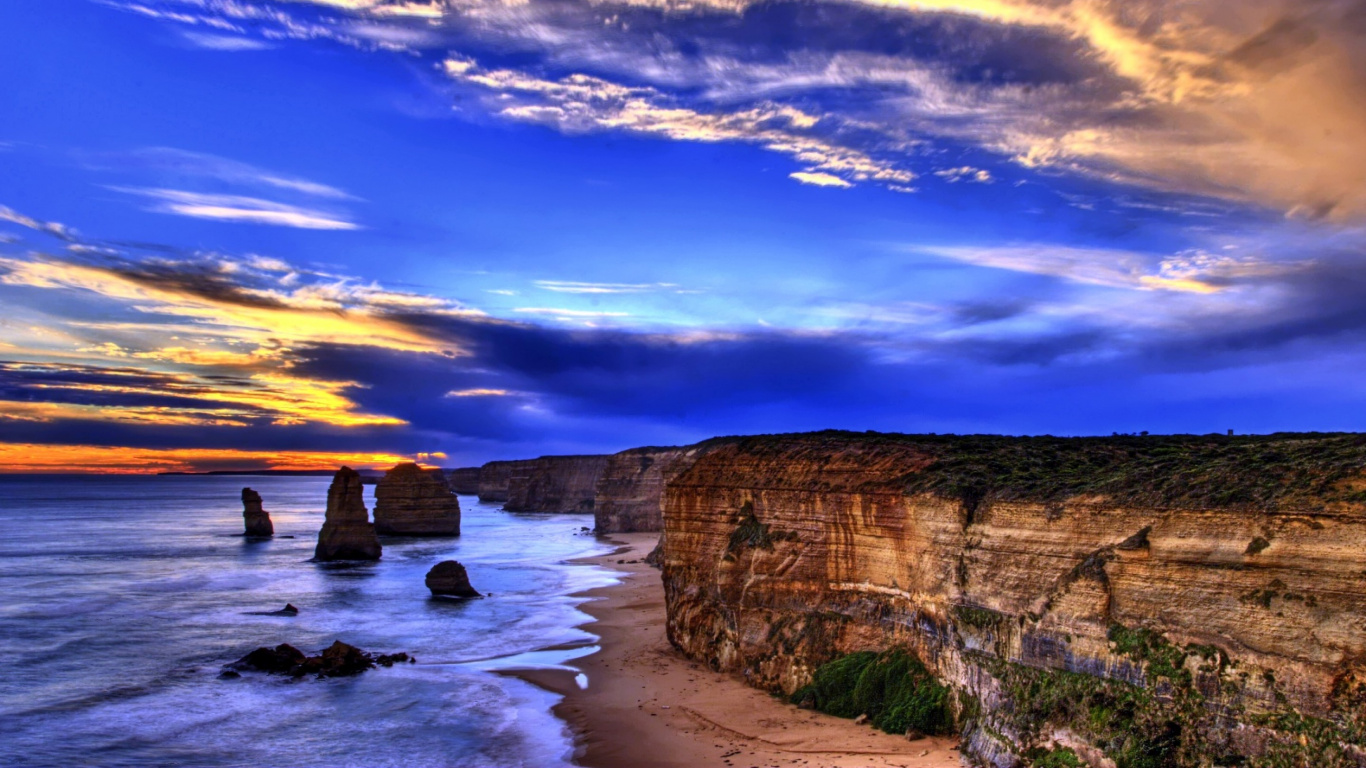 Brown Rock Formation on Sea Under Blue Sky During Daytime. Wallpaper in 1366x768 Resolution