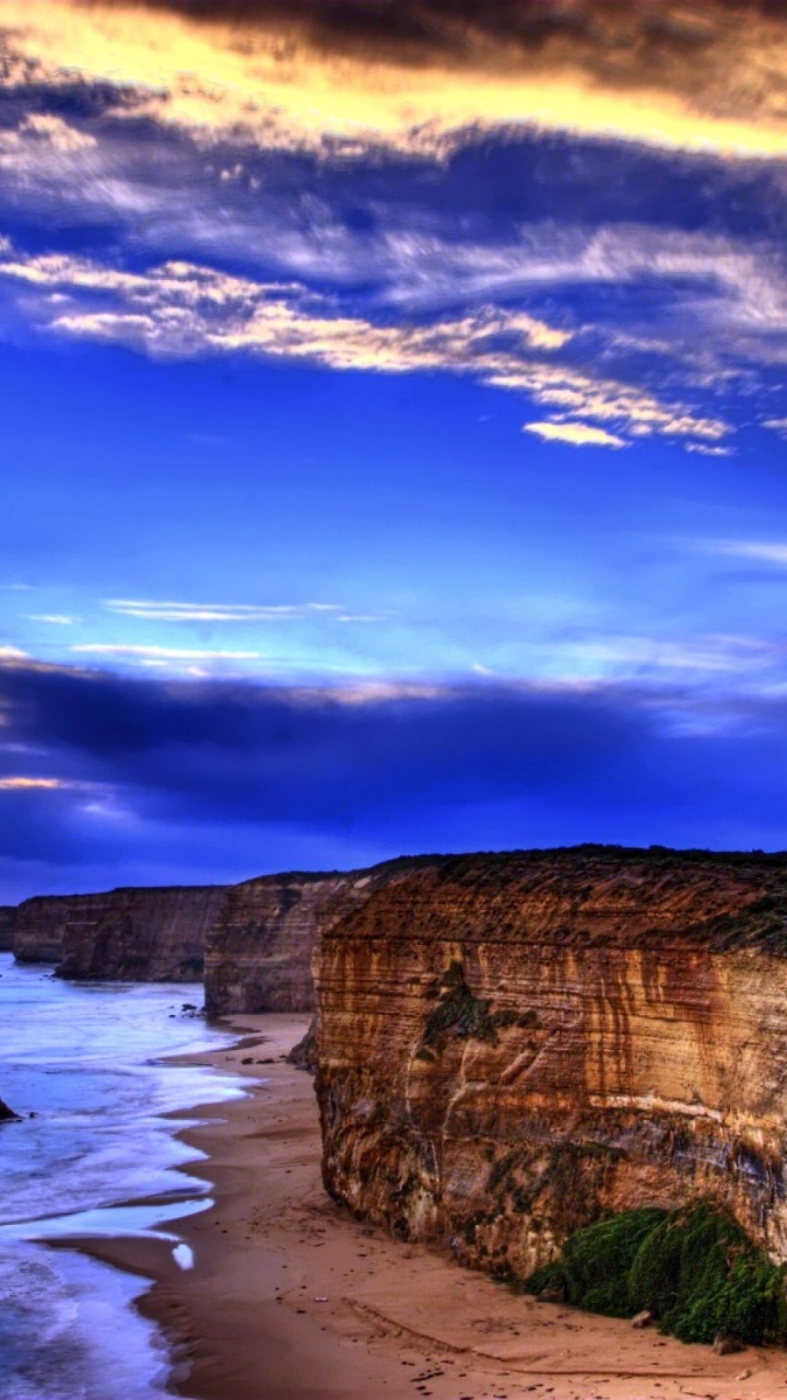 Brown Rock Formation on Sea Under Blue Sky During Daytime. Wallpaper in 720x1280 Resolution