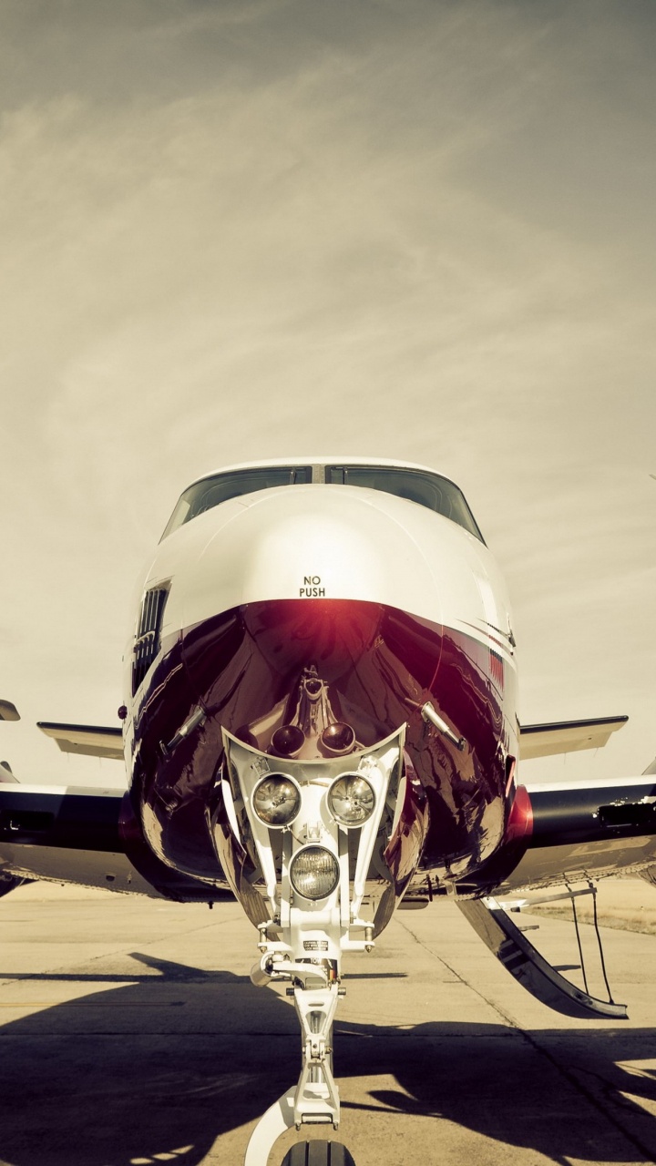 Red and White Airplane on The Ground. Wallpaper in 720x1280 Resolution