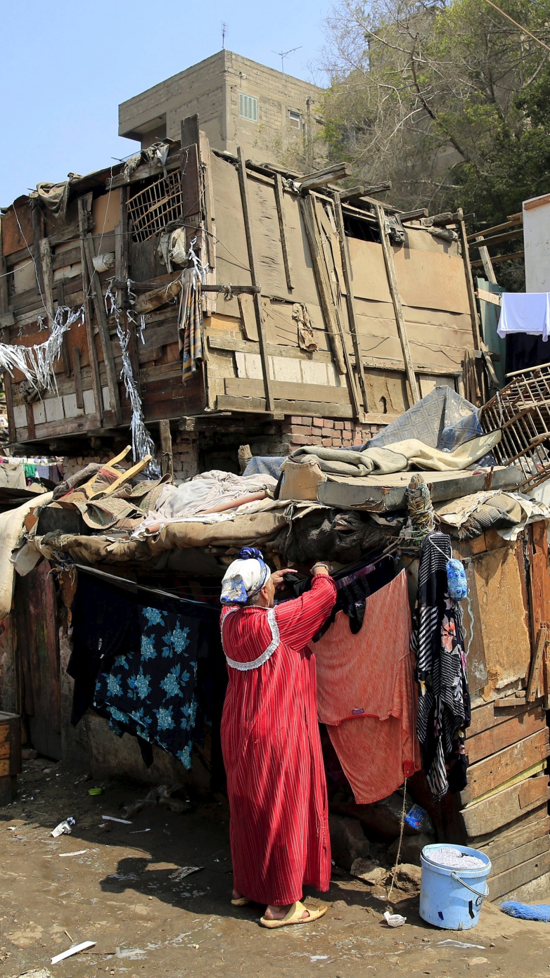 Woman in Red Dress Standing Near Brown Cardboard Boxes During Daytime. Wallpaper in 1080x1920 Resolution