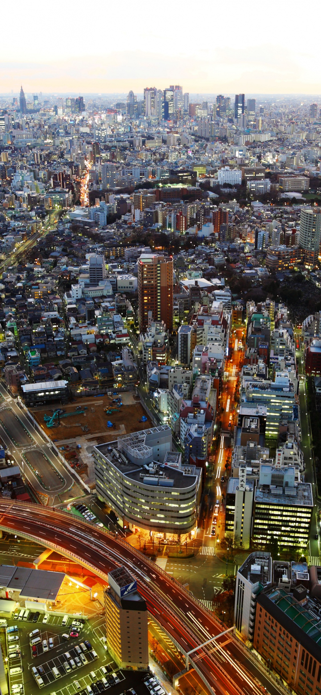 Aerial View of City Buildings During Night Time. Wallpaper in 1125x2436 Resolution